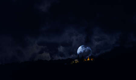 silhouette shot image of big full moon at Wat Phra That Doi Suthep temple ,Chiang mai,Thiland .