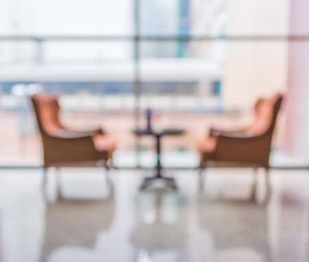 blur image of Beautiful vintage sofa next to window in lobby for background usage.の写真素材
