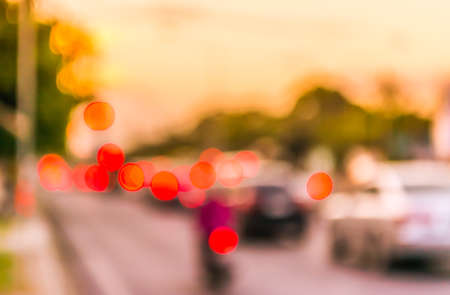 image of blur car on road on evening time for background usage. (vintage tone)の写真素材