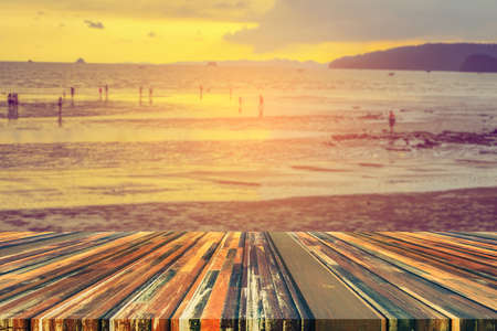wood table and blur sea background