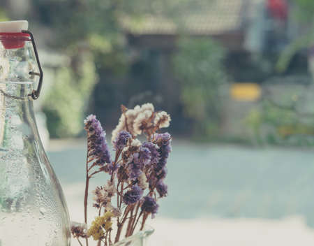 vintage tone image of dry flower and glass bottle for background.の写真素材
