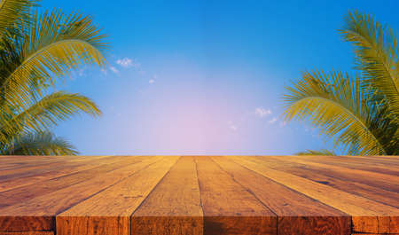 image of wood table and blur coconut tree for background usage.