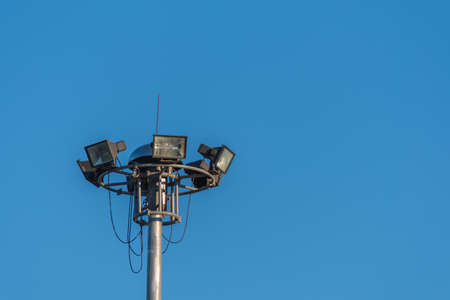 vintage tone image of sport light pole with clear blue sky.の写真素材
