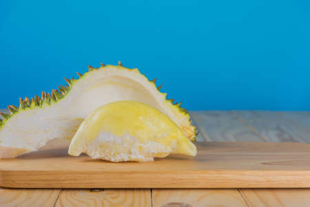 Image of ripe durian with yellow pulp on wood table.の写真素材