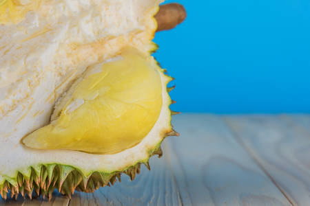 Image of ripe durian with yellow pulp on wood table.の写真素材