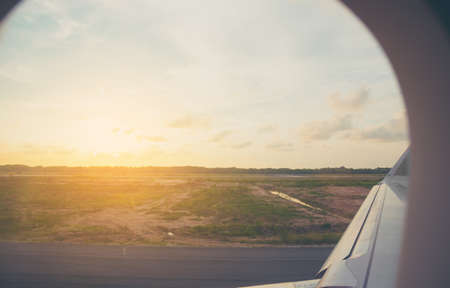 image of air plane park in airport runway with blue sky in background.の写真素材