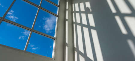 image of office square windows to see blue sky and white clouds in background.の写真素材