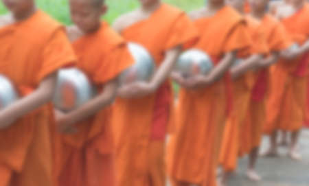 blur image of monk walking on the road.の写真素材