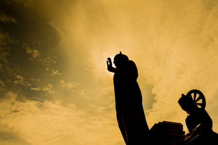 silhouette image of Buddha statue in Wat Phra That Doi Kham temple, Chiang Mai Thailand.の写真素材