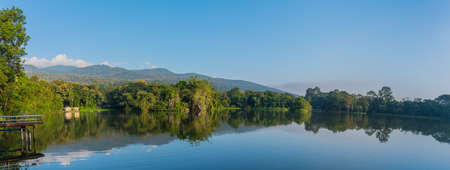 panorama image of lake and the mountain with beautiful blue sky in evening time at ang kaew in Chiang Mai University ,Thailand.の写真素材