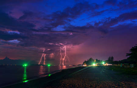 image of Black cloud of Thunder strom covered the city near the beach with many Thunder bolt on sky at Rayong Province Thailandの写真素材