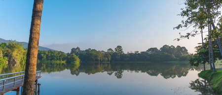 panorama image of lake and the mountain with beautiful blue sky in evening time at ang kaew in Chiang Mai University ,Thailand.の写真素材