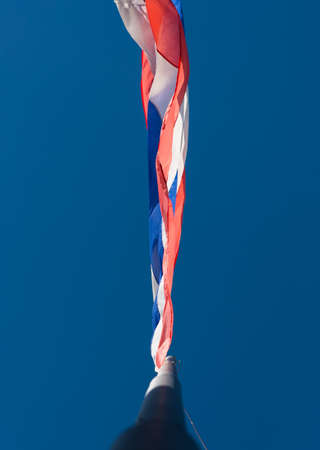 Flag of Thailand with clear blue sky for background.の写真素材