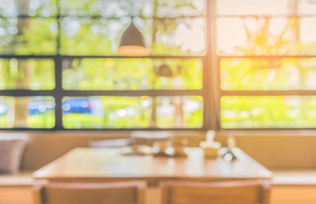 Abstract blur image of coffee shop or restaurant on day time with bokeh  for background usage. (vintage tone)の写真素材
