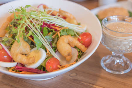 Image of Fresh healthy japanese style shrimp salad with sesame cream dressing on table.の写真素材
