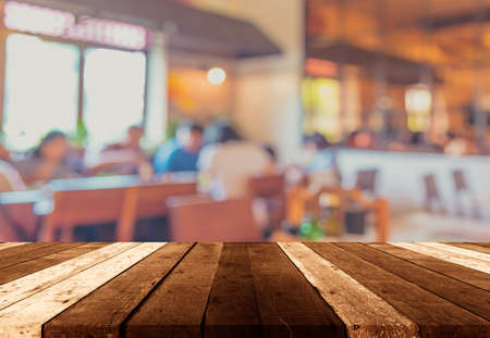 wood table and Coffee shop blur background with bokeh image.(vintage tone)の写真素材