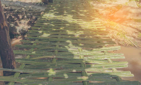 vintage tone image of bamboo bridge across the river .の写真素材