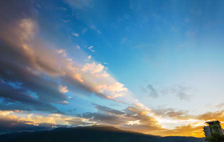 image of dramatic blue sky with warm orange light and mountain in background at Doi Suthep Chiang Mai,Thailand.の写真素材