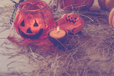 vintage tone image of Halloween pumpkin and vary ornament on wood table with Wooden background.の写真素材