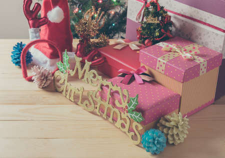 Vintage tone image of Christmas ornaments with the colourful light on the pine tree and vary of...