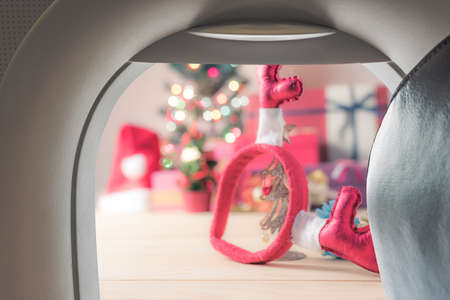Image of plane window and Christmas ornaments on wood floorの写真素材