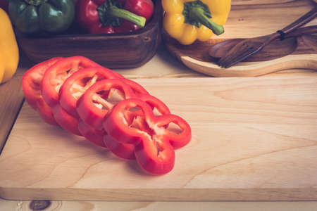sliced sweet pepper on wooden plateの写真素材
