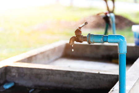 Leaking water faucets flowing into the basin, showing the loss of water without uselessness.の写真素材