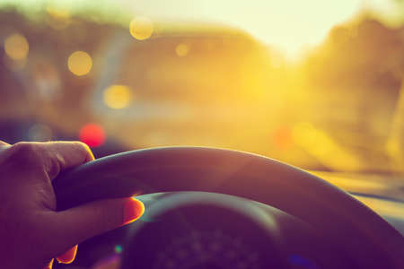 vintage tone image of people driving car on day time for background usage.(take photo from inside...