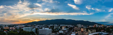 panorama image of sky above modern Chiang Mai city and doi Suthep mountain on evening time view from high angle spot.