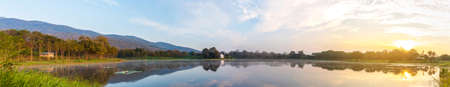 panorama image of lake and mountain on morning time with fog on water surface.の写真素材