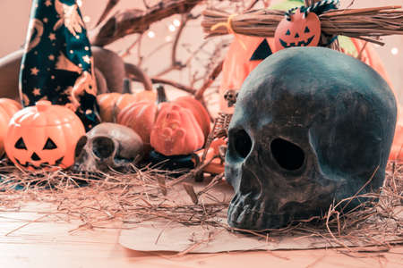 vintage tone image of Halloween pumpkin and a variety of ornaments on wood table with Wooden background.の写真素材