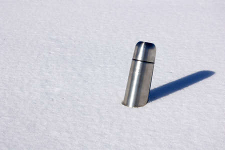 Thermos in snowの写真素材