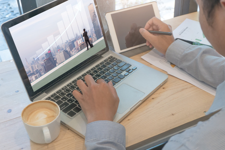Business man working by computer in coffee shopの写真素材