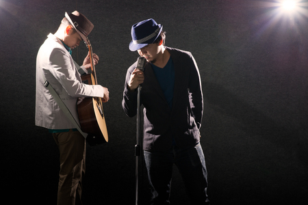 Two musicians playing guitar and singingの写真素材