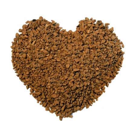Studio macro image of a heart shape comprising 'instant' coffee granules on a white background. Copy space.の写真素材