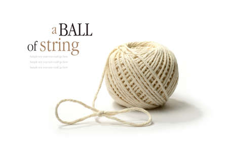 A ball of string with soft shadows against a white background  Copy space 
