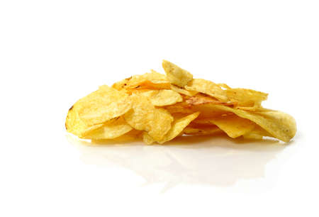 Studio macro of potato chips (or crisps) on a white surface against a white background. Copy space.