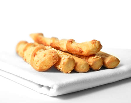 Close up of assorted bread sticks against a white background. Copy space.
