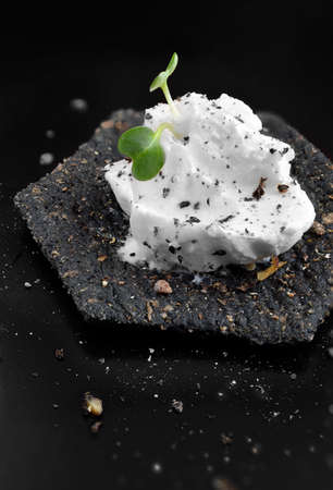 Cream cheese canape with garden cress and cracked black pepper  Copy space 