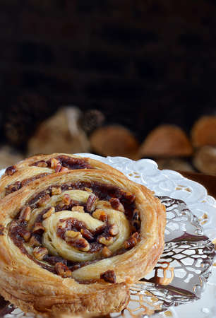 Pain au Pecan and toffee Danish pastry patisserie on a silver dessert plate with white serviette. Copy space.の写真素材