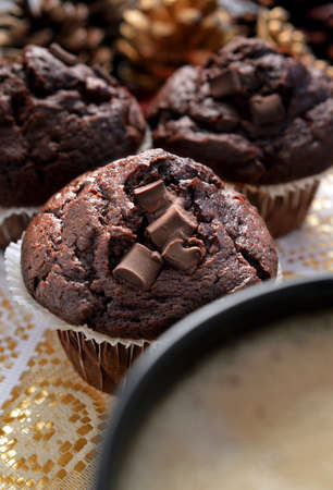 Triple Chocolate Muffins shot in natural light  Mug of hot fresh cappuccino in the foreground  The perfect image for your breakfast menu design の写真素材