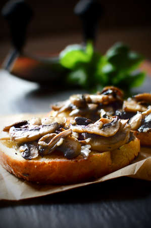 Garlic mushrooms on bruschetta in selective natural light. The perfect image for your restaurant menu cover. Copy space.の写真素材