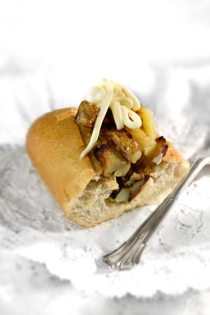 Freshly baked warm baguette filled with French Fries and mayonnaise dressing against a light background. Selective focus. Generous accommodation for copy space.の写真素材