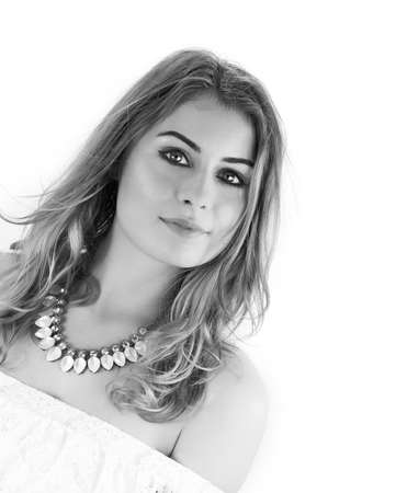 Beautiful young white model smiling to camera against a white background. Concept image for dental, health, beauty, hair, make up and fashion. Copy space.の写真素材