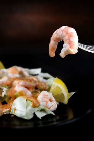 Classic prawn cocktail dish with atlantic black tiger prawns in 1000 island dressing with lettuce and cayenne pepper. Copy space. The perfect image for your menu design cover design.の写真素材