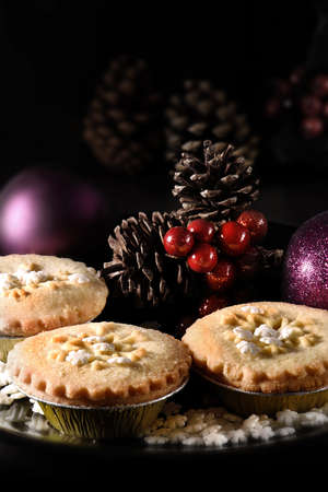 Festive Rhubarb and stem ginger pies in a rustic setting with creative lighting with generous accommodation for copy space. The ideal image for your Christmas or Thanksgiving cover design art.の写真素材