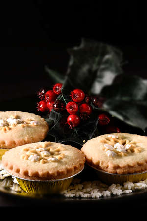 Festive Rhubarb and stem ginger pies in a rustic setting with creative lighting with generous accommodation for copy space. The ideal image for your Christmas or Thanksgiving cover design art.の写真素材