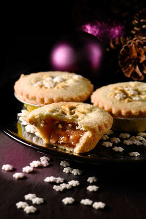 Festive Rhubarb and stem ginger pies in a rustic setting with creative lighting with generous accommodation for copy space. The ideal image for your Christmas or Thanksgiving cover design art.の写真素材