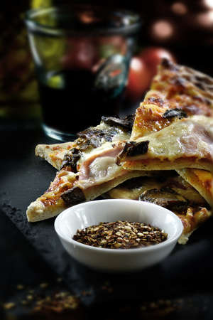 Prosciutto Ham, Portobellini Mushroom & Mascarpone pizza shot against a rustic background with a...