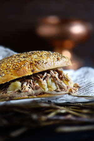 Rustic pulled roast pork sandwich with apple sauce against a dark background with generous accommodation for copy space.の写真素材